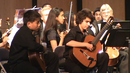 Keving Huang and Chris Monteverde performn as guitar soloists with members of The South Florida Youth Symphony Orchestra.